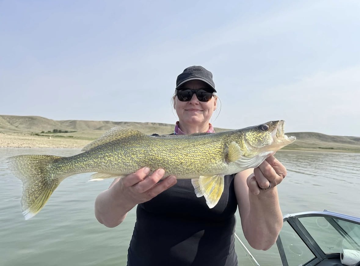 Angler with a walleye on a prairie lake